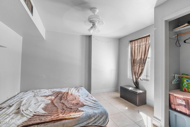 bedroom with light tile patterned floors, visible vents, and a ceiling fan