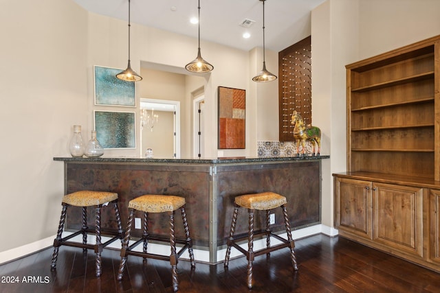 bar featuring decorative light fixtures and dark hardwood / wood-style floors