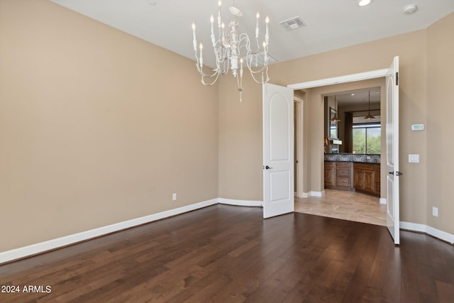 interior space featuring dark wood-type flooring and a notable chandelier