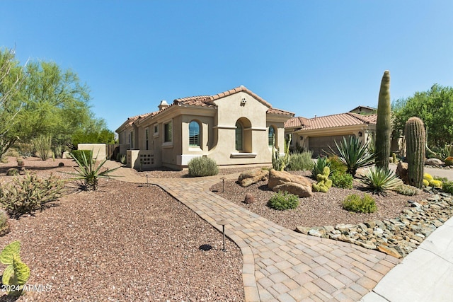 mediterranean / spanish-style home featuring a garage