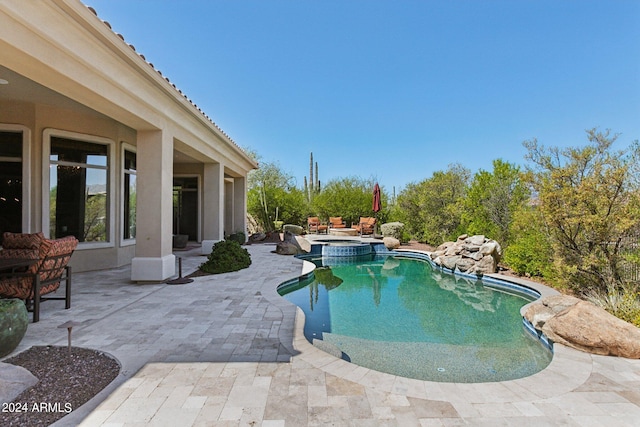 view of pool featuring an in ground hot tub and a patio area