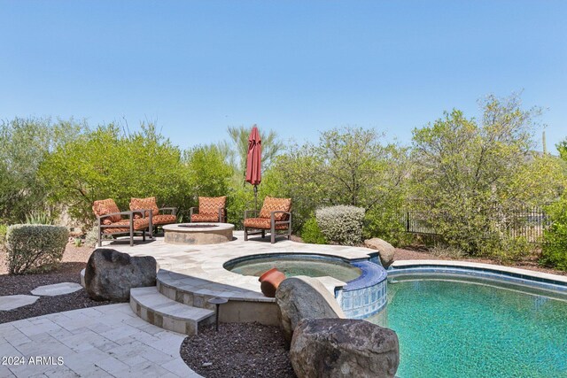 view of pool with a patio and an in ground hot tub