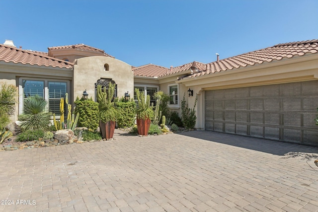 mediterranean / spanish home with a garage