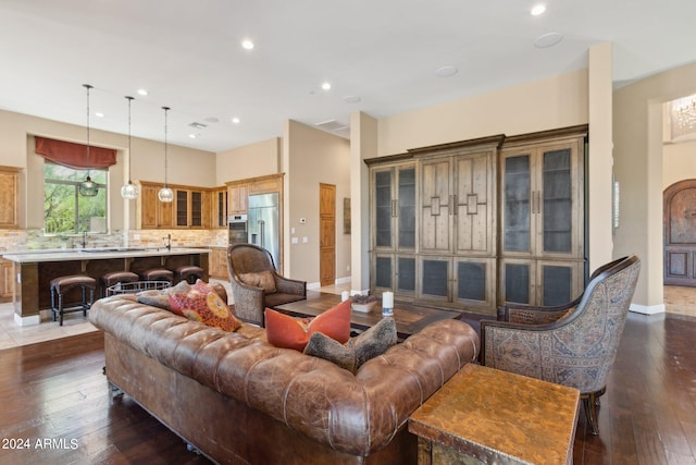 living room featuring dark hardwood / wood-style floors and sink