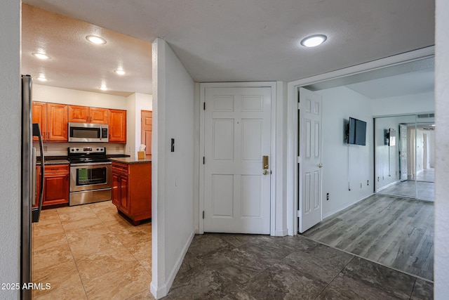 kitchen with stainless steel appliances and a textured ceiling