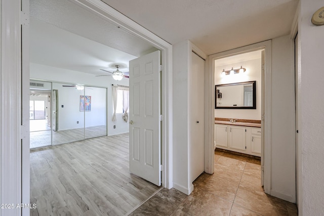 hall featuring sink and light hardwood / wood-style floors