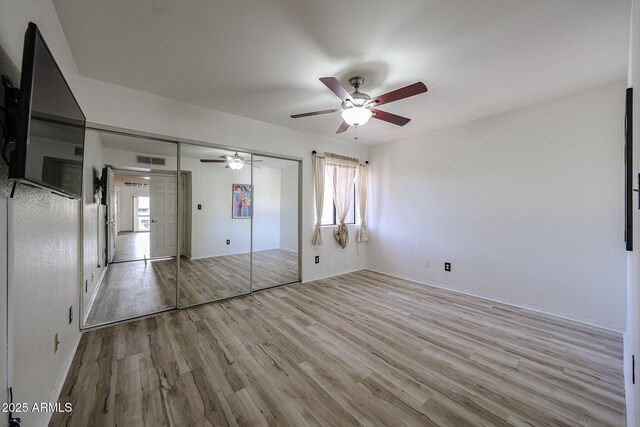 unfurnished bedroom with a closet, ceiling fan, and light hardwood / wood-style flooring