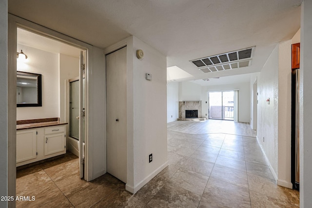 hall featuring light tile patterned flooring