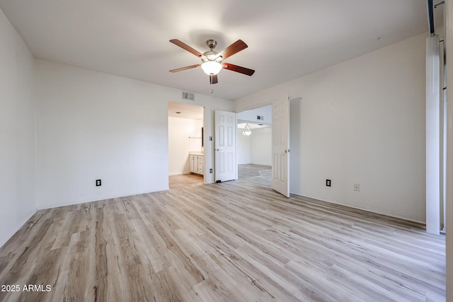 unfurnished bedroom with ceiling fan, ensuite bath, and light hardwood / wood-style floors