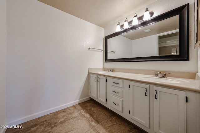 bathroom featuring vanity and a textured ceiling