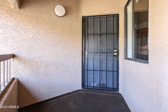 doorway to property featuring a balcony