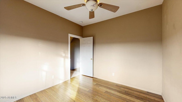 spare room with light wood-type flooring and ceiling fan