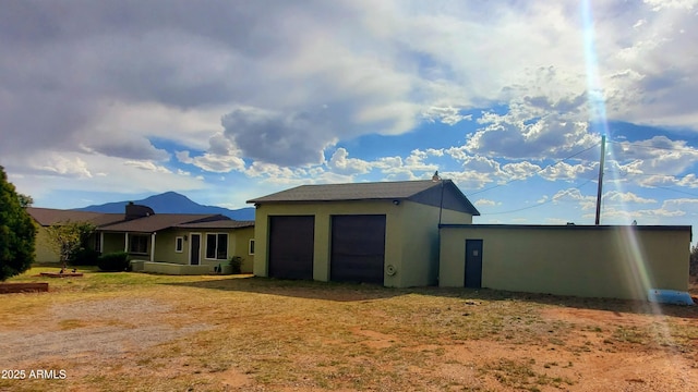 1005 W Purdy Ln, Bisbee, AZ 85603 - back of house featuring a garage and stucco siding