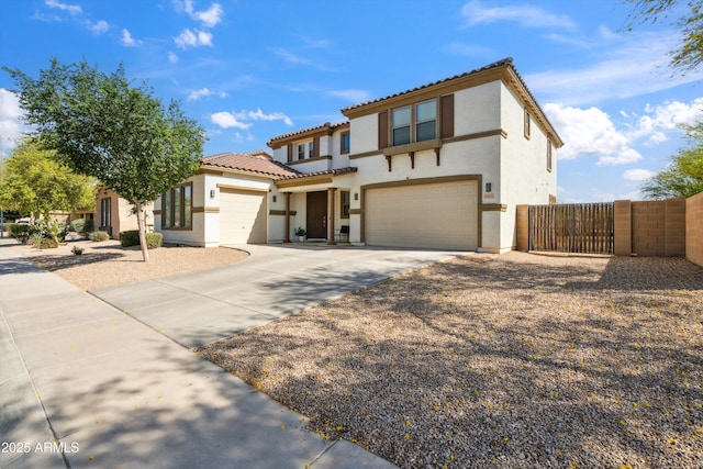 view of front facade featuring stucco siding, driveway, an attached garage, a tiled roof, and fence