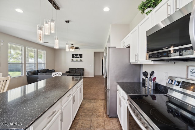 kitchen with white cabinetry, open floor plan, pendant lighting, and appliances with stainless steel finishes