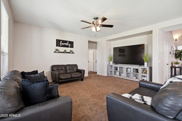 carpeted living room with ceiling fan
