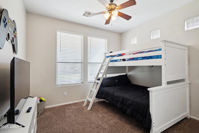 carpeted bedroom with visible vents, baseboards, and a ceiling fan