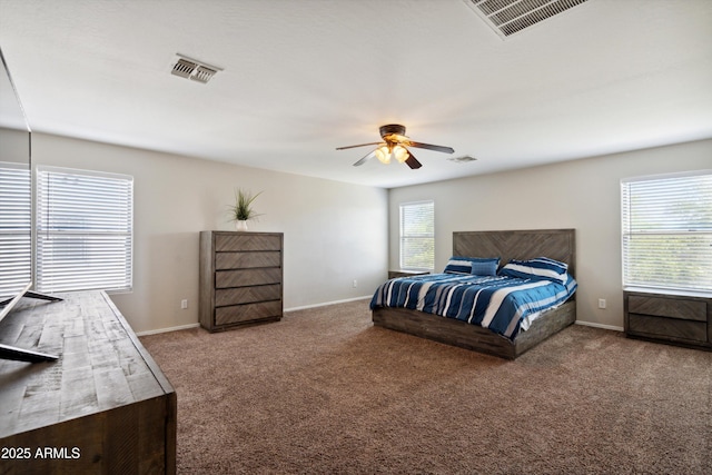 carpeted bedroom featuring visible vents, baseboards, and ceiling fan