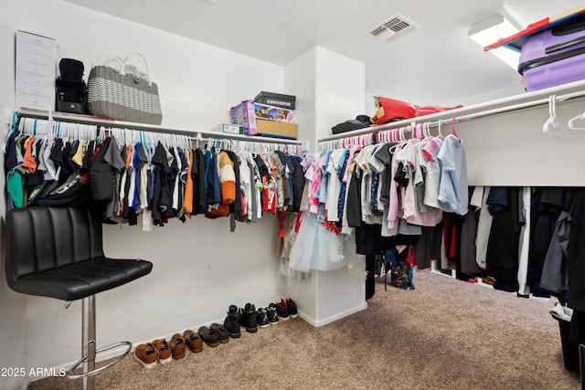walk in closet featuring carpet and visible vents