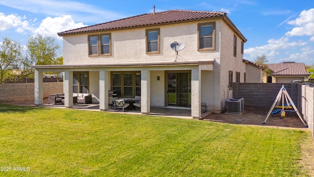back of property featuring outdoor lounge area, stucco siding, a patio area, a fenced backyard, and a yard