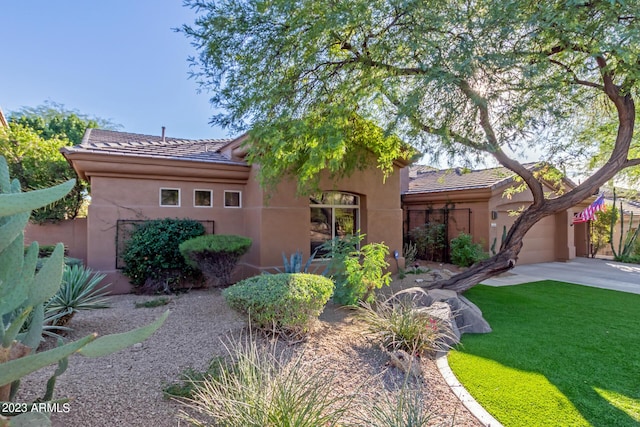 view of front of home featuring a garage and a front lawn