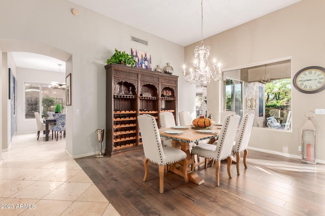 dining area with an inviting chandelier and light hardwood / wood-style flooring