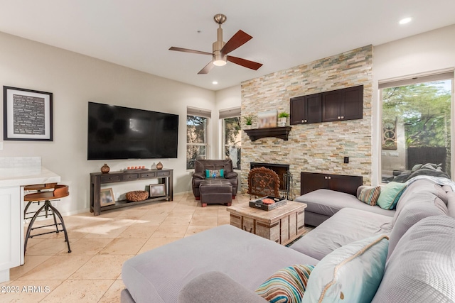 living room with ceiling fan and light tile patterned floors