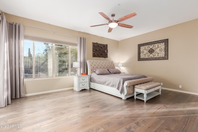 bedroom with ceiling fan and light hardwood / wood-style floors