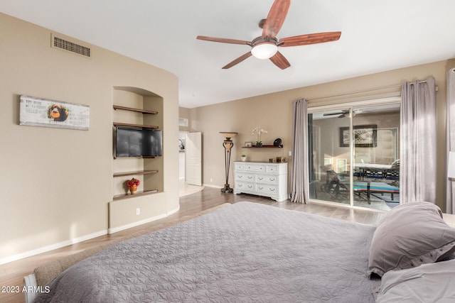 bedroom with hardwood / wood-style flooring, access to outside, and ceiling fan