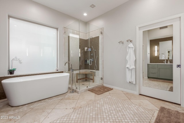 bathroom featuring vanity, shower with separate bathtub, and tile patterned floors