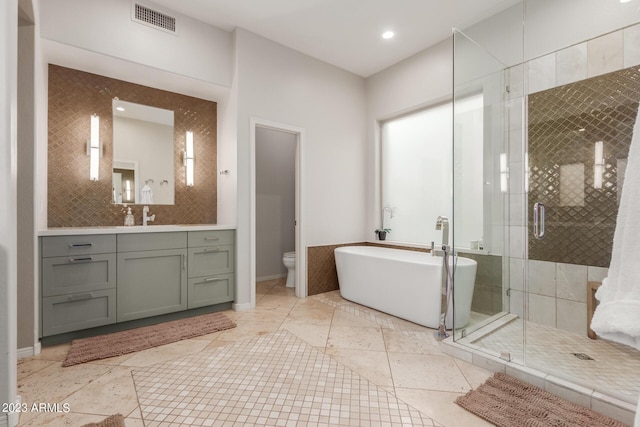 full bathroom with vanity, toilet, tile patterned floors, and plus walk in shower