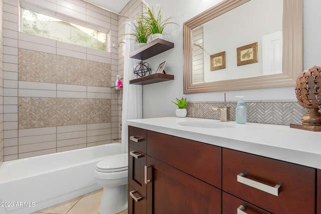 full bathroom with backsplash, tiled shower / bath combo, vanity, tile patterned floors, and toilet