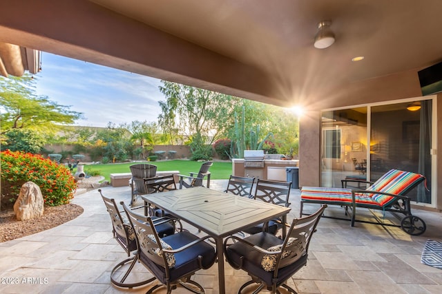 view of patio / terrace with exterior kitchen and a grill