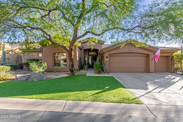 view of front of home with a garage and a front yard