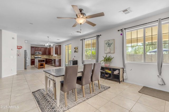 27053 N 172nd Ln, Surprise, AZ 85387 - dining room with light tile patterned floors, a chandelier, and ceiling fan