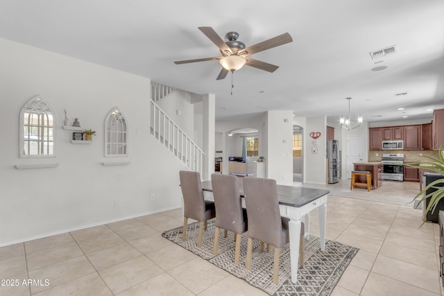 27053 N 172nd Ln, Surprise, AZ 85387 - dining area featuring stairs, light tile patterned floors, a chandelier, and a ceiling fan