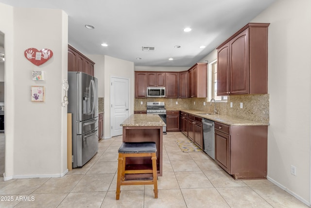 27053 N 172nd Ln, Surprise, AZ 85387 - kitchen with stainless steel appliances, backsplash, light stone countertops, light tile patterned flooring, and recessed lighting