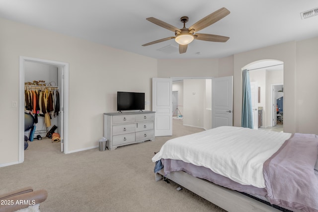 27053 N 172nd Ln, Surprise, AZ 85387 - bedroom with a walk in closet, carpet flooring, a closet, connected bathroom, and a ceiling fan