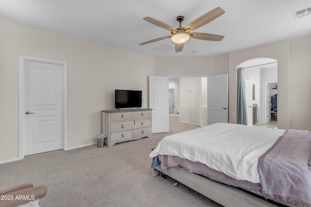27053 N 172nd Ln, Surprise, AZ 85387 - carpeted bedroom featuring connected bathroom, arched walkways, and a ceiling fan