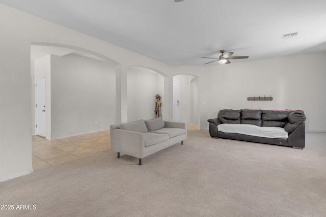 27053 N 172nd Ln, Surprise, AZ 85387 - tiled living room featuring arched walkways, ceiling fan, and carpet flooring