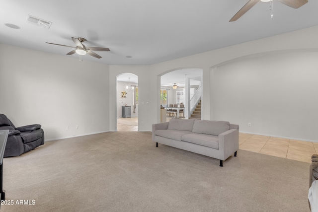 27053 N 172nd Ln, Surprise, AZ 85387 - living area featuring ceiling fan, arched walkways, light colored carpet, stairs, and light tile patterned floors