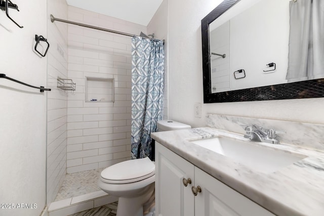 bathroom featuring vanity, a stall shower, and toilet