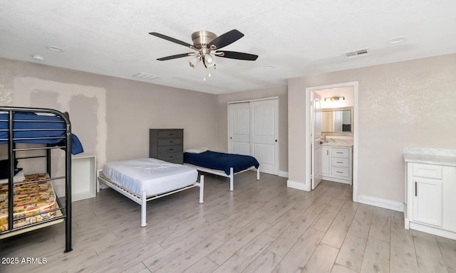 bedroom with baseboards, a ceiling fan, light wood finished floors, and visible vents