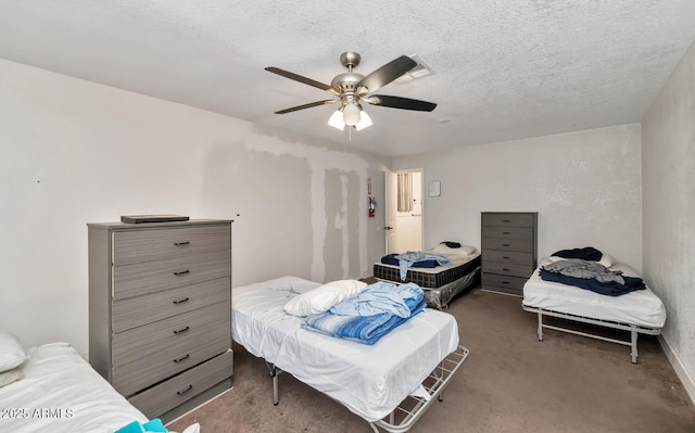 bedroom with carpet flooring, a textured ceiling, and ceiling fan