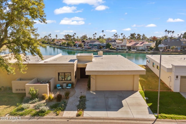 view of front facade featuring a water view and a garage