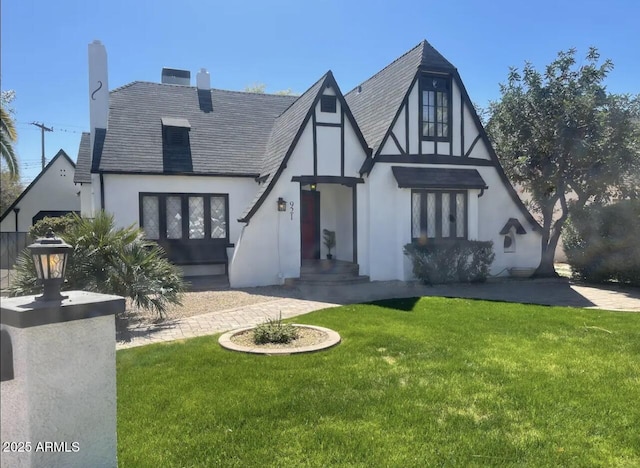 tudor house featuring a front lawn