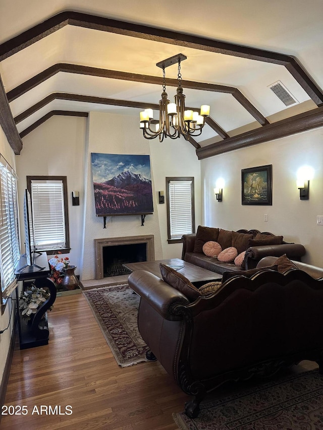 living room with vaulted ceiling with beams, dark wood-type flooring, and a chandelier