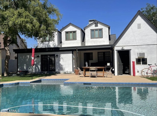 back of house featuring an outdoor living space and a patio