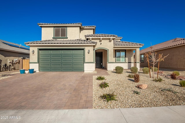 mediterranean / spanish-style home with a garage