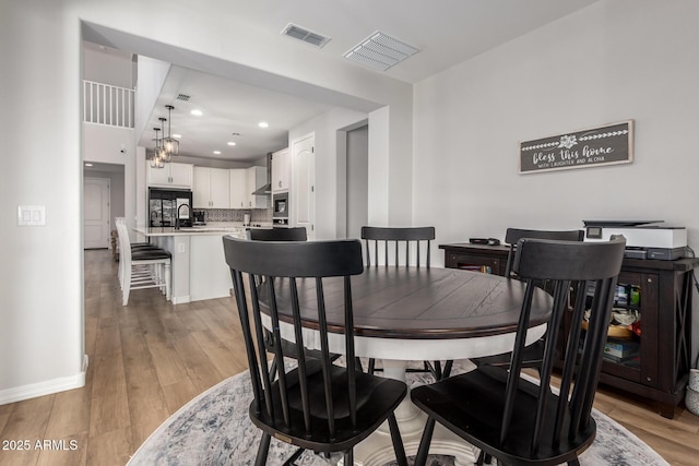 dining room with wood-type flooring